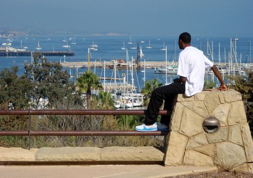 Young man admires the harbor from Winslow Maxwell Overlook