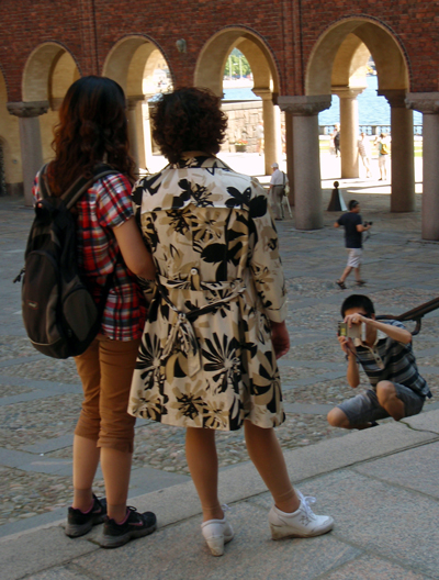 A Japanese tourist takes a photo of his mom and sis